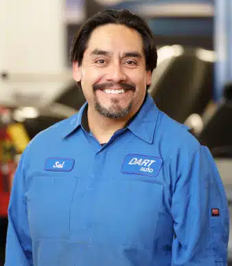 Smiling auto mechanic in blue work shirt