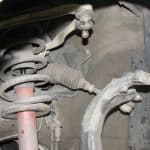 Car suspension system with coil spring and control arm