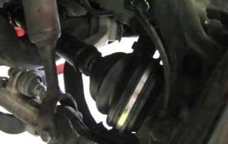 Close-up of car CV joint and suspension components